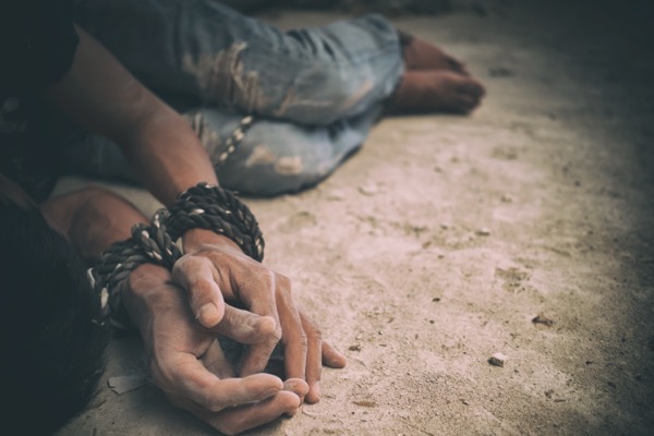 image of a man hands tied on the ground